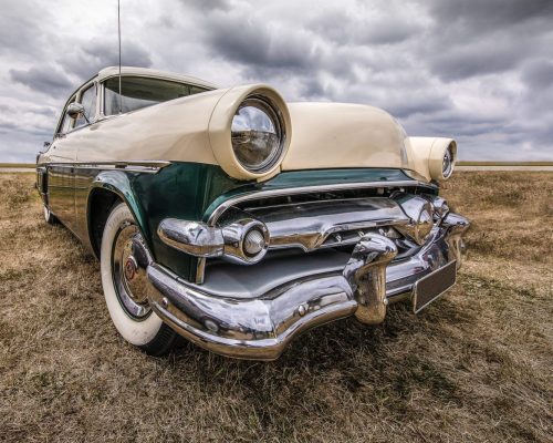 Closeup shot of a vehicle on a dry field under a cloudy sky A closeup shot of a vehicle on a dry field under a cloudy sky